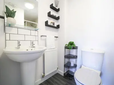 a white bathroom with a sink and a toilet at Canyke Fields in Bodmin