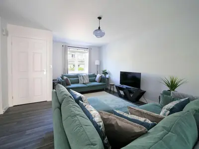 a living room with a couch and a tv at Canyke Fields in Bodmin