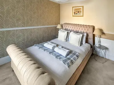 a bed with two pillows on it in a room at Bora House in Newquay
