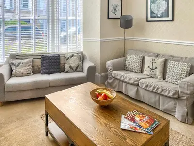 a living room with a couch and a coffee table at Bora House in Newquay