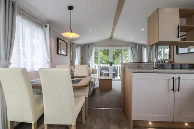 a kitchen and dining room with a table and chairs at The Maples, no 56 in St Austell