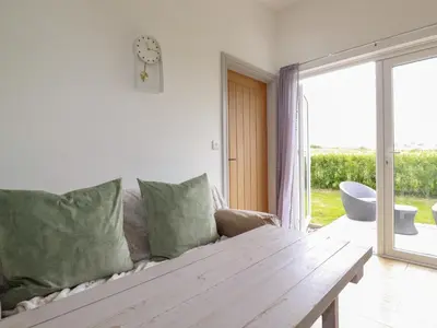 a living room with a couch and a wooden table at The Tinystore in Bodmin