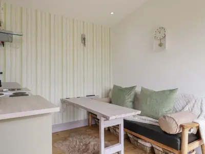 a living room with a couch and a table at The Tinystore in Bodmin