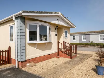 a small house with a window and a fence at Lazy Days in Padstow