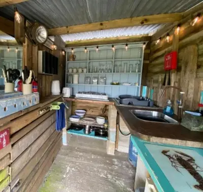 a kitchen with a counter and a sink in it at Emilies Bell Tent in St Ives