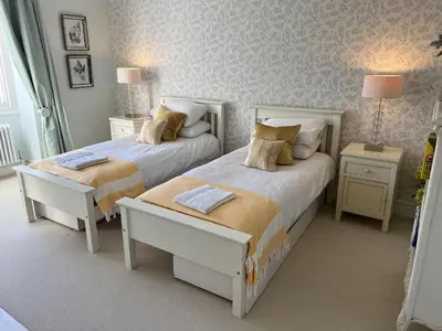 a bedroom with two beds and two night stands at Trenare in Truro