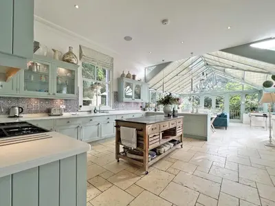 a large kitchen with white cabinets and a kitchen island at Trenare in Truro
