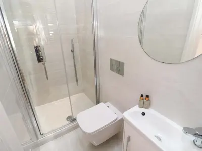a bathroom with a shower and a toilet and a sink at Carn Brea in Redruth