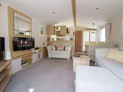 a living room with a couch and a tv at Meadow 46 in Newquay