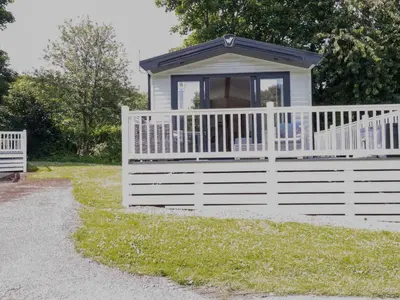 a white fence with a window on top of it at Meadow 46 in Newquay