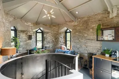 a large kitchen with a large tub in a stone wall at Castle by the Beach with Sea Views Portreath in Redruth