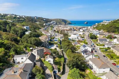 an aerial view of a small town next to the ocean at Castle by the Beach with Sea Views Portreath in Redruth