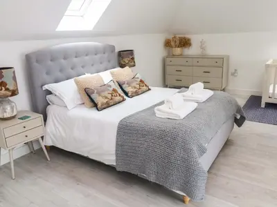 a bedroom with a large bed with towels on it at Miramar in St Ives