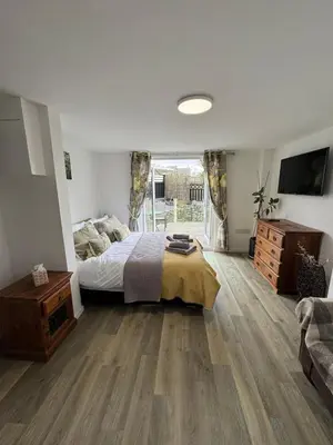 a bedroom with a bed and a large window at Adorable 3 Bedroom House, Near Newquay 11 Miles in Saint Dennis