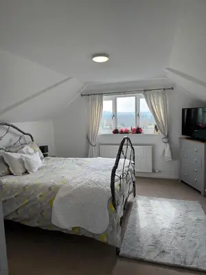 a bedroom with a bed and a television and a window at Adorable 3 Bedroom House, Near Newquay 11 Miles in Saint Dennis