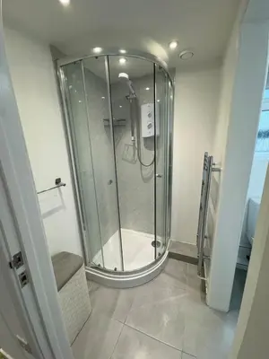 a glass shower in a bathroom with a toilet at Adorable 3 Bedroom House, Near Newquay 11 Miles in Saint Dennis