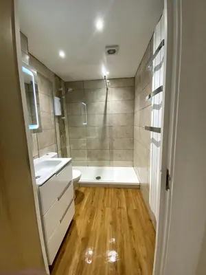 a bathroom with a tub and a sink and a shower at Lovely 1 bedroom flat in the heart of Newquay in Newquay