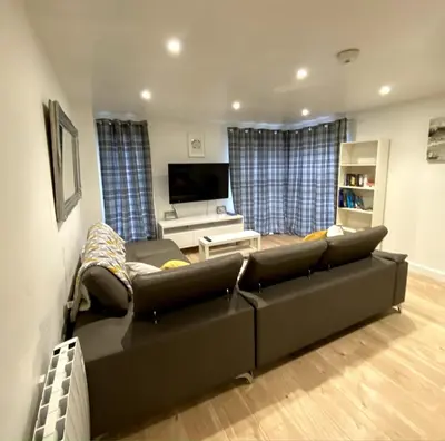 a living room with a couch and a flat screen tv at Lovely 1 bedroom flat in the heart of Newquay in Newquay