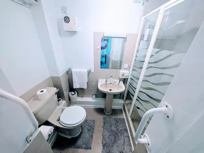 a small bathroom with a toilet and a sink at Parkside Lodge Manor in Camelford