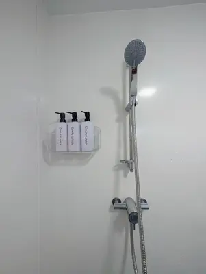 a bathroom with a shower with a shower head at Parkside Lodge Manor in Camelford