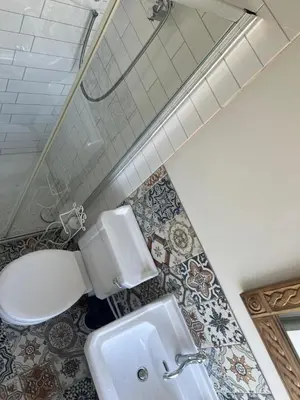 a bathroom with a toilet and a sink at Cornwall Large Beach House Sea & Beach Views - 4 Bedrooms & 3 Bathrooms in Looe