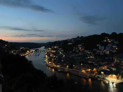 a view of a river at night at Cornwall Large Beach House Sea & Beach Views - 4 Bedrooms & 3 Bathrooms in Looe