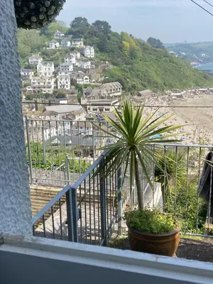 a plant in a pot on a balcony with a city at Cornwall Large Beach House Sea & Beach Views - 4 Bedrooms & 3 Bathrooms in Looe