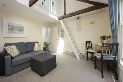 a living room with a couch and a table at Bessie Ellens Cottage - 1 Pet Welcome - Central Location - Free WiFi in Fowey