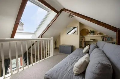 a living room with a couch and a large window at Bessie Ellens Cottage - 1 Pet Welcome - Central Location - Free WiFi in Fowey
