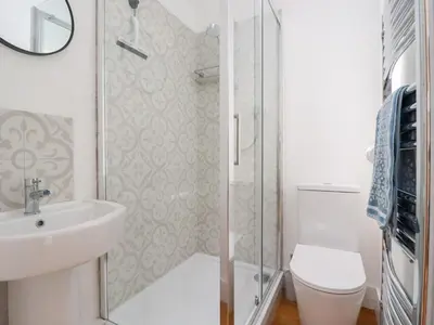 a bathroom with a shower and a sink and a toilet at Glendale in Port Isaac