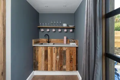 a kitchen with a wooden counter with a sink at Luxury Cornish Cottage & Modern Cabin with Garden, Central St Agnes in St. Agnes