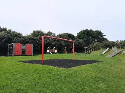 a park with a playground with a red pole at Luxury Cornish Cottage & Modern Cabin with Garden, Central St Agnes in St. Agnes