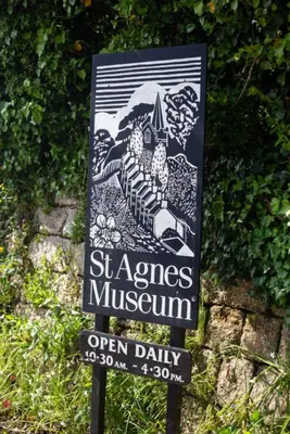 a sign for the sespes museum on a street at Luxury Cornish Cottage & Modern Cabin with Garden, Central St Agnes in St. Agnes