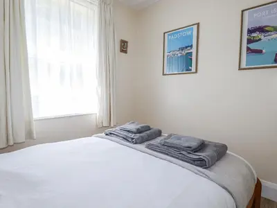 a bedroom with a bed with two towels on it at Sea Ledge in Tintagel