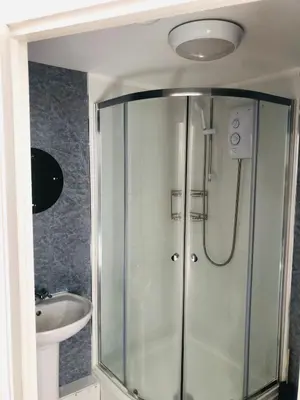 a bathroom with a shower and a sink at The Studio in St Austell