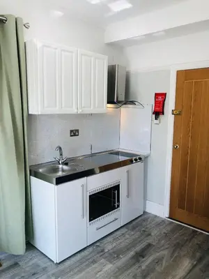 a small kitchen with a sink and a microwave at The Studio in St Austell