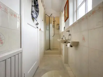 a small bathroom with a sink and a shower at Lantreath in Saint Mawes