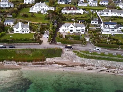 an aerial view of a town with houses and the water at Lantreath in Saint Mawes