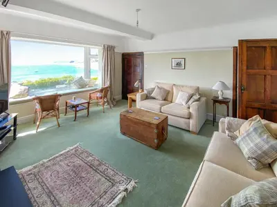 a living room with a couch and a table at Lantreath in Saint Mawes