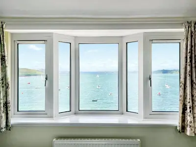 a window with four views of the water at Lantreath in Saint Mawes