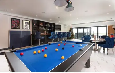 a billiard room with a pool table and chairs at La Casita in Breage