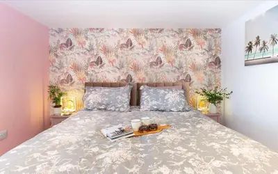 a bedroom with a bed with a tray of food on it at La Casita in Breage