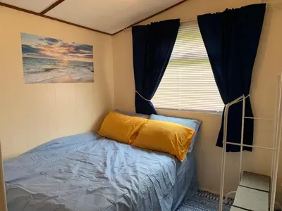 a small bedroom with a bed and a window at Seabreeze Cottage in Padstow