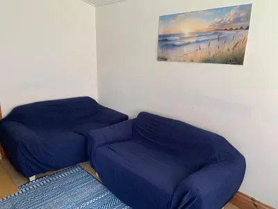 a blue bean bag chair in a room with a painting at Seabreeze Cottage in Padstow