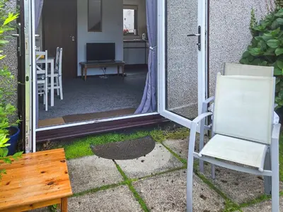 a room with a mirror and a chair and a table at Strawberry Hill in Hayle