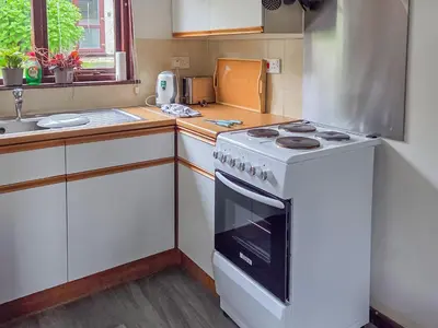 a kitchen with a stove and a sink at Strawberry Hill in Hayle