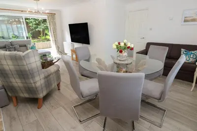 a living room with a table and chairs at Jaluna in St Ives