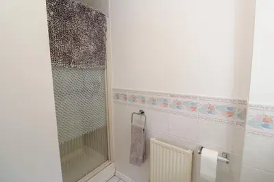 a bathroom with a shower and a towel at Jaluna in St Ives