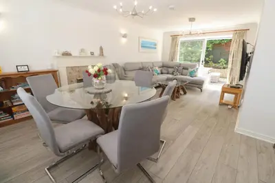 a living room with a table and chairs and a couch at Jaluna in St Ives