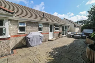 a brick house with a patio in front of it at Jaluna in St Ives